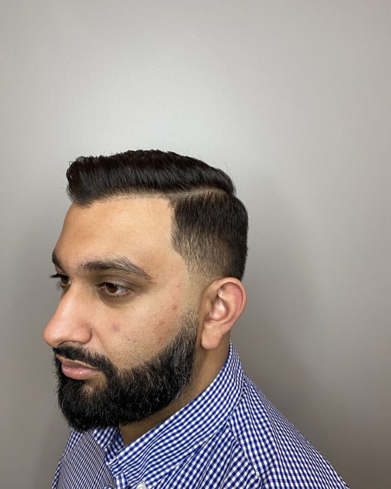 Men's side-part cut with a low fade and a shaped full beard, Avalon Salon Calgary