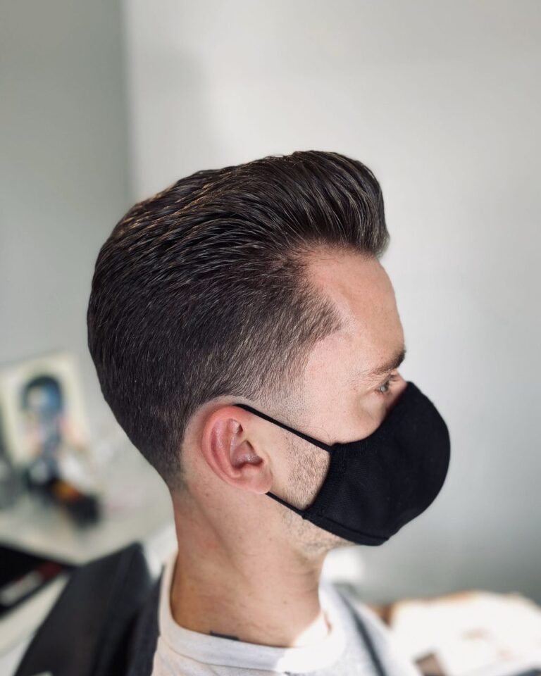 Men's slicked-back cut with volume on top and tapered sides, client in a face mask, Avalon Salon Calgary