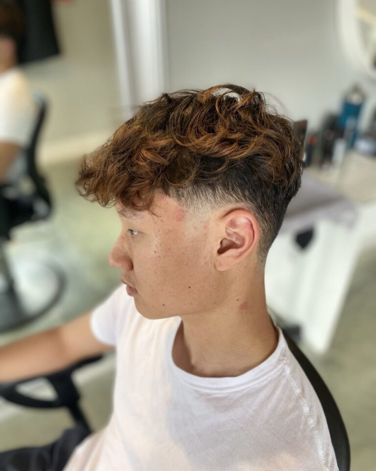 Men's curly textured top with a low taper fade, Avalon Salon Calgary
